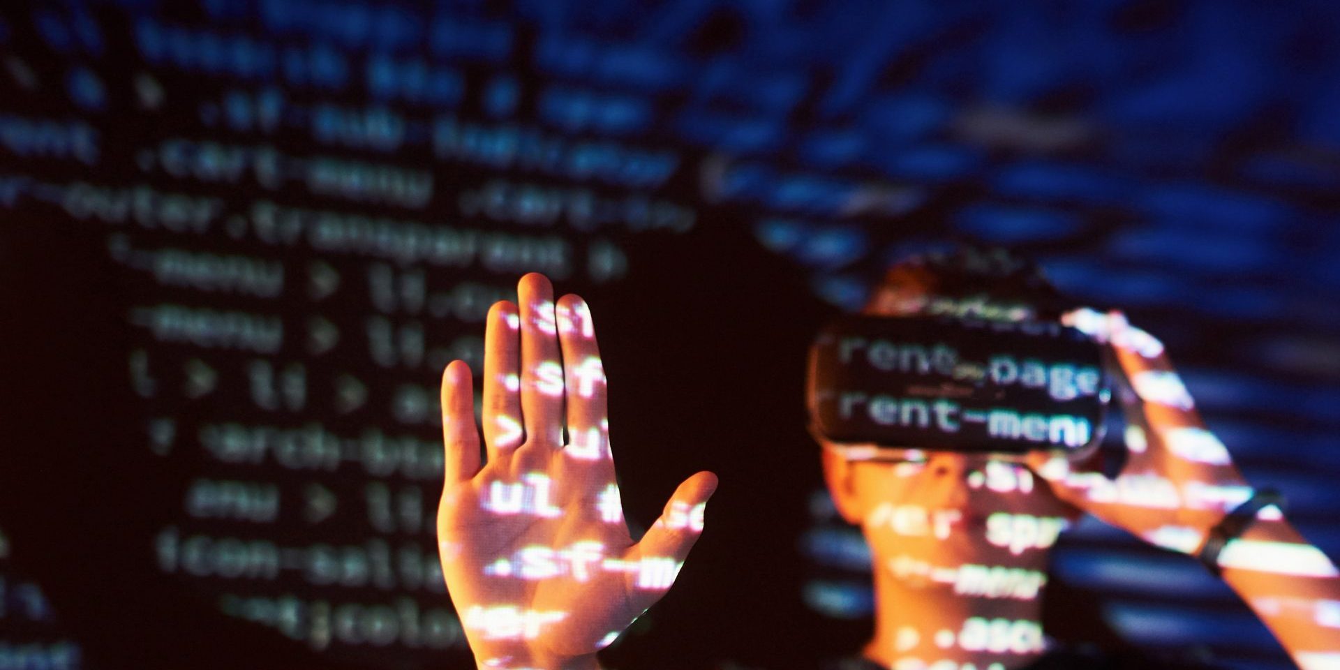 Double exposure of a caucasian man and Virtual reality headset is presumably a gamer or a hacker cracking the code into a secure network or server, with lines of code