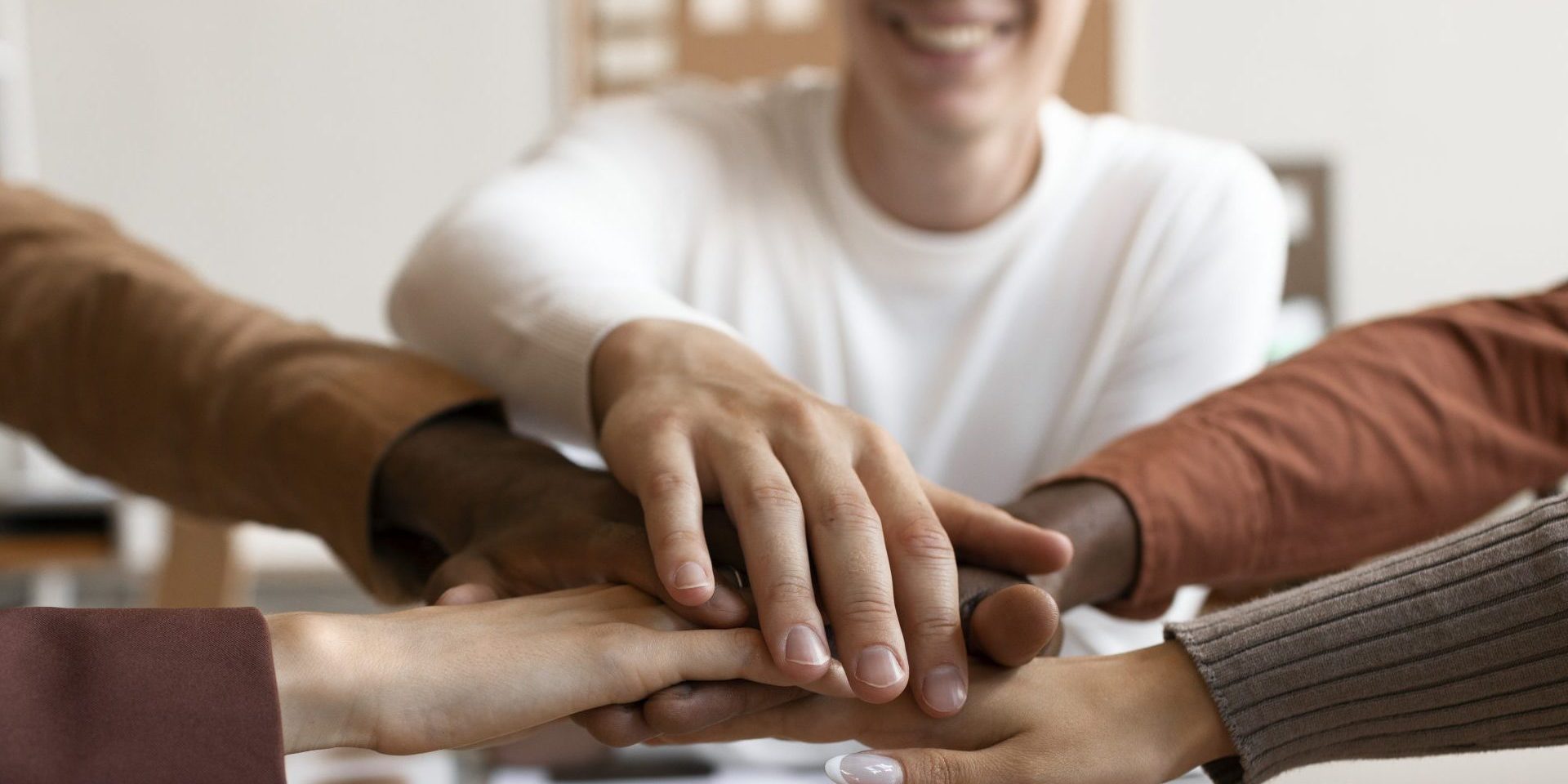 side-view-people-putting-hands-together